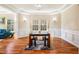 Sun-filled dining room with hardwood floors, modern table, and views to the living area at 2129 Glade Valley Ln, Morrisville, NC 27560