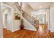 Elegant foyer features a staircase with iron spindles and hardwood floors throughout at 2129 Glade Valley Ln, Morrisville, NC 27560