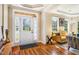 Inviting foyer with hardwood floors, decorative door, and view into a stylish living room at 2129 Glade Valley Ln, Morrisville, NC 27560