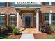 Detailed view of front door with decorative columns and stylish lighting fixtures at 2129 Glade Valley Ln, Morrisville, NC 27560