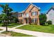 Beautiful brick home with manicured lawn and sidewalk leading to the entrance at 2129 Glade Valley Ln, Morrisville, NC 27560
