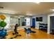 Bright gym features exercise equipment, weights, and a large mirror for a complete fitness experience at home at 2129 Glade Valley Ln, Morrisville, NC 27560
