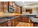 Kitchen features granite countertops, stainless steel appliances, and custom wood cabinets at 2129 Glade Valley Ln, Morrisville, NC 27560