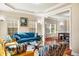 Spacious living room with hardwood floors and modern furniture opens to the dining area at 2129 Glade Valley Ln, Morrisville, NC 27560