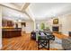 Open-concept living room featuring hardwood floors, fireplace, and seamless transition to the kitchen at 2129 Glade Valley Ln, Morrisville, NC 27560