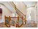 Elegant staircase featuring wooden railings with iron balusters leading to the upper level at 2129 Glade Valley Ln, Morrisville, NC 27560