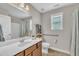 Bright bathroom featuring neutral walls, a window, and handicap-accessible features at 22 Evie Dr, Smithfield, NC 27577