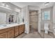 Well-lit bathroom with double vanity, glass-enclosed shower, and handicap-accessible features at 22 Evie Dr, Smithfield, NC 27577