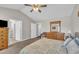 Cozy bedroom featuring neutral walls, a ceiling fan, and a quaint dresser at 22 Evie Dr, Smithfield, NC 27577