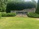 Stone community sign surrounded by manicured landscaping at 22 Evie Dr, Smithfield, NC 27577