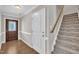 Inviting entryway showcasing hardwood floors, staircase, and elegant interior door at 22 Evie Dr, Smithfield, NC 27577
