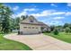 Well-maintained one-story home featuring a large driveway and a two-car attached garage at 22 Evie Dr, Smithfield, NC 27577