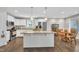 Modern kitchen with island, white cabinets, granite countertops, and stainless steel appliances at 22 Evie Dr, Smithfield, NC 27577