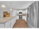 Bright kitchen features white cabinets, granite countertops, stainless steel appliances, and wood flooring at 22 Evie Dr, Smithfield, NC 27577