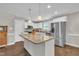 Bright kitchen features a center island with granite countertops and stainless steel appliances at 22 Evie Dr, Smithfield, NC 27577