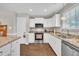 Bright kitchen features white cabinets, granite countertops, and stainless steel appliances at 22 Evie Dr, Smithfield, NC 27577