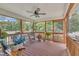 Covered and screened porch featuring wood ceiling, table and chairs, and view of backyard at 22 Evie Dr, Smithfield, NC 27577