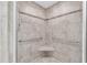 Modern tiled shower with built-in bench and grab bars at 22 Evie Dr, Smithfield, NC 27577
