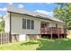 Side view of home featuring a deck, finished basement, and a well-maintained backyard at 23 Northern Way Ct, Durham, NC 27712