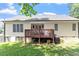 Rear exterior showcases a well-manicured lawn, a cozy deck, and attractive siding at 23 Northern Way Ct, Durham, NC 27712
