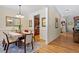 Inviting dining room featuring elegant wainscoting, a chandelier, and wood floors at 23 Northern Way Ct, Durham, NC 27712