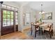 A lovely dining room features a wood floor, a window with shutters, and a wooden table and chairs at 23 Northern Way Ct, Durham, NC 27712