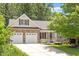 Charming home with stone accents, a two-car garage, and accessible ramp at 23 Northern Way Ct, Durham, NC 27712