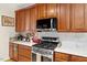 Updated kitchen with stainless steel range and appliances, marble countertops, and wooden cabinets at 23 Northern Way Ct, Durham, NC 27712