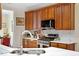 Modern kitchen featuring wooden cabinets, stainless steel appliances, and marble countertops at 23 Northern Way Ct, Durham, NC 27712