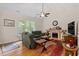 Spacious living room boasts a fireplace, vaulted ceiling, hardwood floors, and large windows for ample lighting at 23 Northern Way Ct, Durham, NC 27712