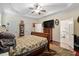 Comfortable main bedroom with a tray ceiling, ceiling fan, and an attached bathroom at 23 Northern Way Ct, Durham, NC 27712