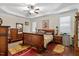 Comfortable main bedroom with tray ceiling, ceiling fan, and abundant natural light at 23 Northern Way Ct, Durham, NC 27712
