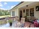 Covered patio with ample seating providing views of the surrounding landscape at 23 Northern Way Ct, Durham, NC 27712