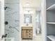 Modern bathroom featuring white marble style tile, stylish vanity, and updated fixtures at 2300 Radius Cir, Sanford, NC 27330
