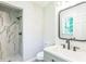 Modern bathroom featuring a sleek vanity, updated fixtures, and a tiled shower with a glass enclosure at 2300 Radius Cir, Sanford, NC 27330