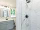 Updated bathroom featuring a walk-in shower with white marble-style tile and sleek, modern fixtures at 2300 Radius Cir, Sanford, NC 27330