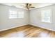 Bedroom featuring wood flooring, two windows, and neutral walls for a relaxing atmosphere at 2300 Radius Cir, Sanford, NC 27330