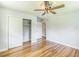 Empty bedroom with hardwood floors, a ceiling fan, and closet space at 2300 Radius Cir, Sanford, NC 27330