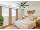 Inviting bedroom featuring plush bedding, a unique decorative collection, wood floors and bright light at 2300 Radius Cir, Sanford, NC 27330