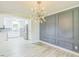 Bright dining room featuring modern wainscoting and updated lighting, with view to the kitchen at 2300 Radius Cir, Sanford, NC 27330