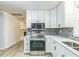 Stylish kitchen with white cabinets, stainless steel appliances, and gray tiled backsplash at 2300 Radius Cir, Sanford, NC 27330