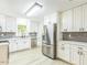 Bright kitchen with white cabinets, stainless steel appliances, and a modern backsplash at 2300 Radius Cir, Sanford, NC 27330