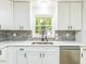Beautiful kitchen featuring white cabinets, stainless steel dishwasher, and modern fixtures at 2300 Radius Cir, Sanford, NC 27330