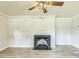 Bright living room featuring a classic fireplace, neutral walls, and hardwood floors at 2300 Radius Cir, Sanford, NC 27330