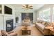 Cozy living room with fireplace, plush seating, dining area and bright windows at 2300 Radius Cir, Sanford, NC 27330