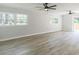Open living room with a ceiling fan, light gray paint, lots of natural light, and new wood flooring at 2300 Radius Cir, Sanford, NC 27330
