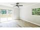 Living room with access to a wood patio through sliding glass doors and featuring gray wood flooring at 2300 Radius Cir, Sanford, NC 27330
