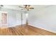 Main bedroom featuring wood flooring, a ceiling fan, and an attached bathroom with a tiled shower at 2300 Radius Cir, Sanford, NC 27330