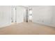 A bright bedroom features neutral carpet, white walls and trim, and access to a bathroom and closet at 235 Mccauley St # D, Chapel Hill, NC 27516