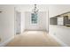 Bright dining area with a chandelier, natural light, and easy access to the kitchenette, perfect for everyday meals at 235 Mccauley St # D, Chapel Hill, NC 27516